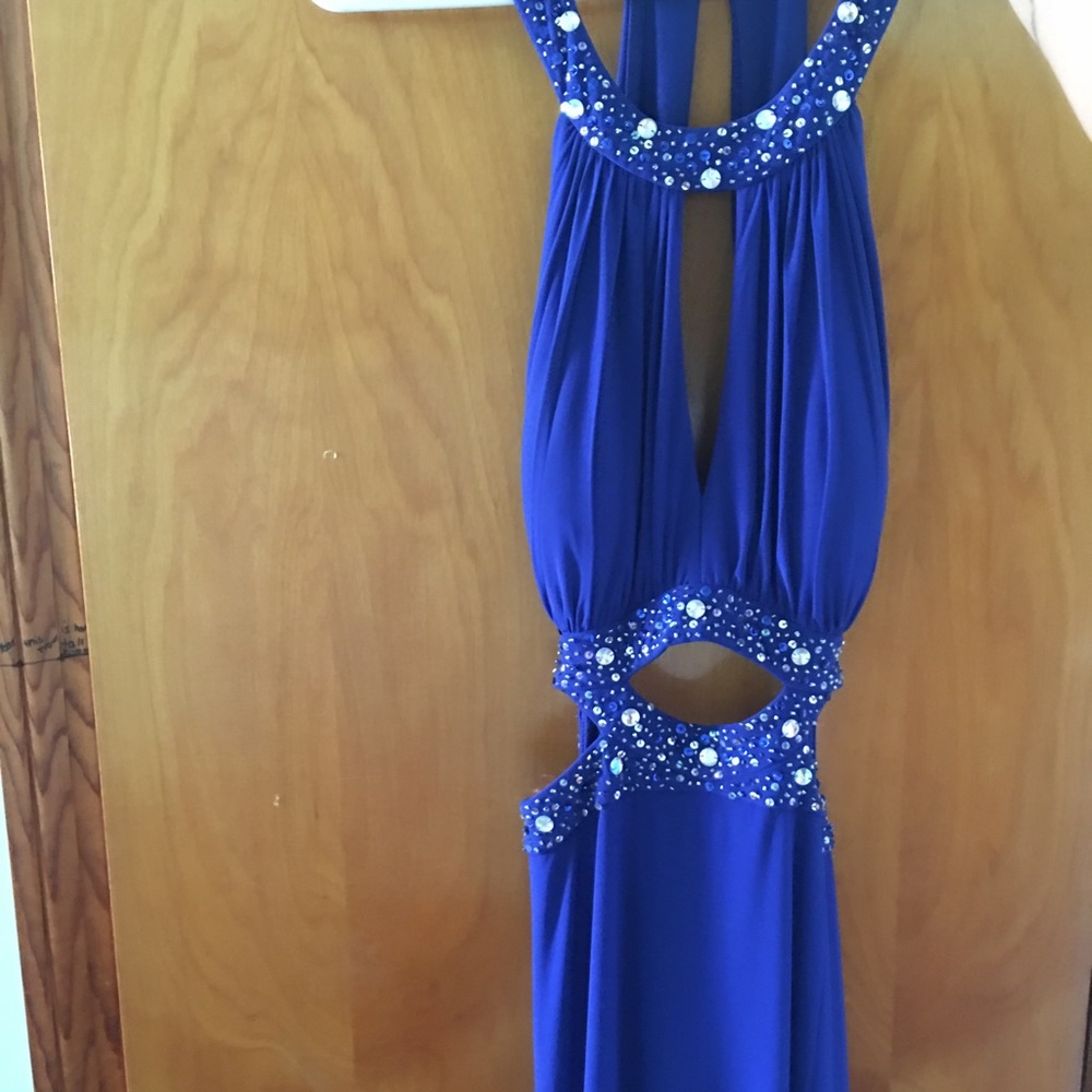 Royal blue gown with diamond accents and cutouts.